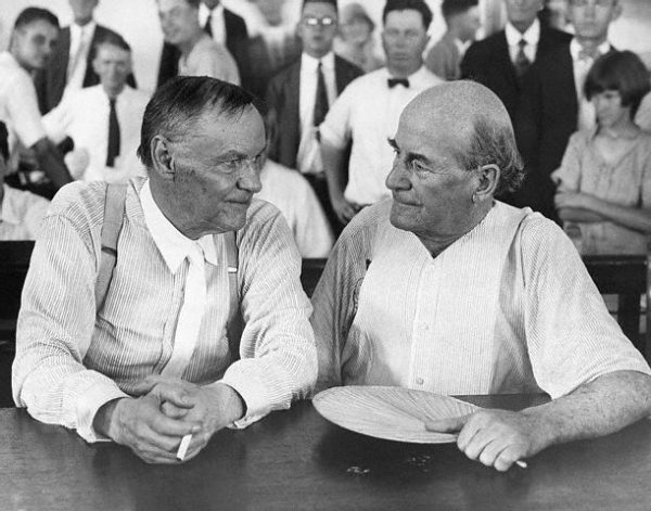Clarence Darrow, a famous Chicago lawyer, and William Jennings Bryan, defender of Fundamentalism, have a friendly chat in a courtroom during the Scopes evolution trial.  Darrow defended John T. Scopes, a biology teacher, who decided to test the new Tenessee law banning the teaching of evolution. Bryan took the stand for the prosecution as a bible expert. The trial in 1925 ended in conviction of Scopes. ca. 1925 Dayton, Tennessee, USA