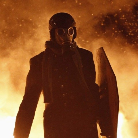 masked_demonstrator_in_fire